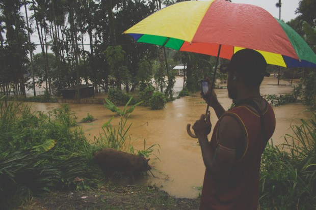 A man stops and takes a picture on his mobile phone
